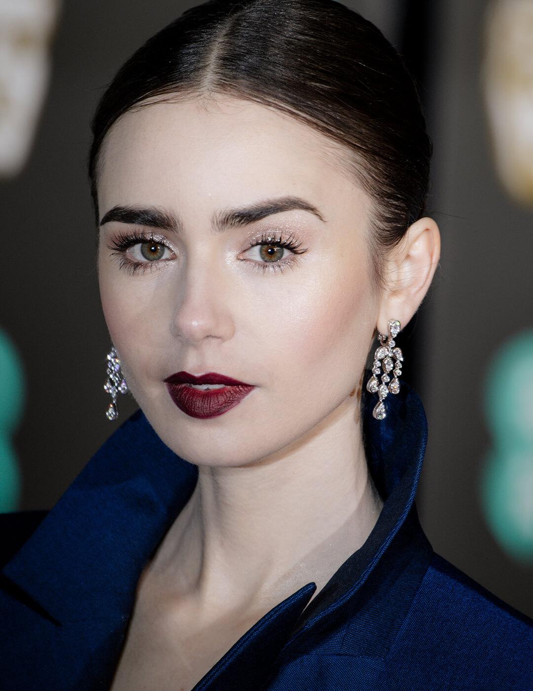 Close-up of Lily Collins rocking shimmery eye makeup and burgundy lips Mobile