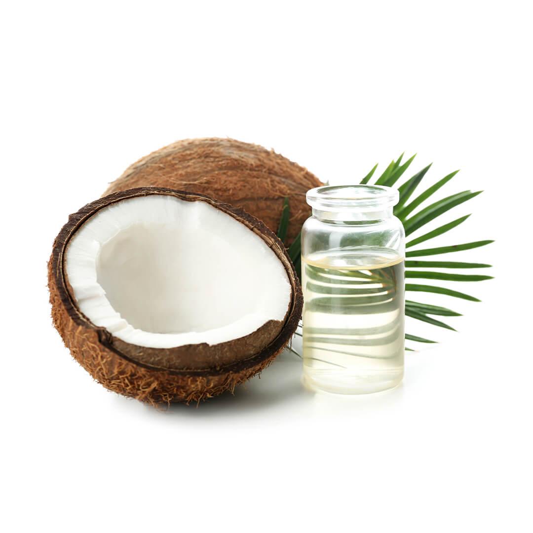 Image of coconut halves and a bottle of coconut oil on white background Mobile