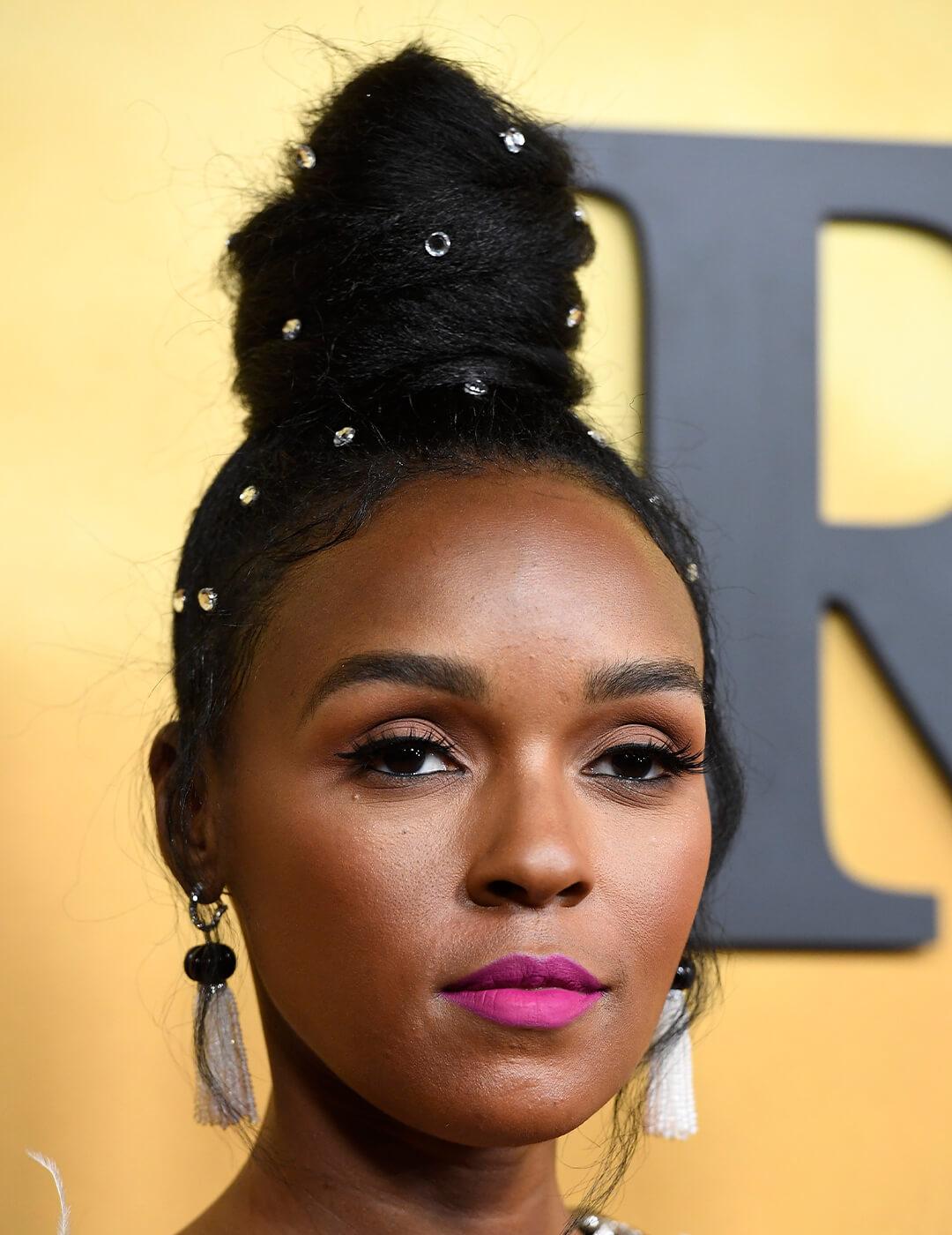 Janelle Monáe rocking a top bun embellished with crystals Mobile