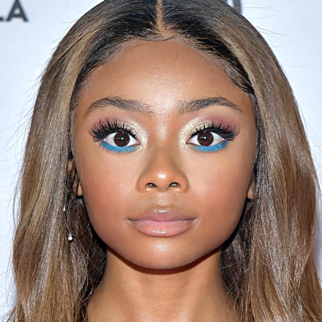 Close-up image of Skai Jackson rocking a rose gold eyeshadow and blue lower lash eyeliner look Mobile