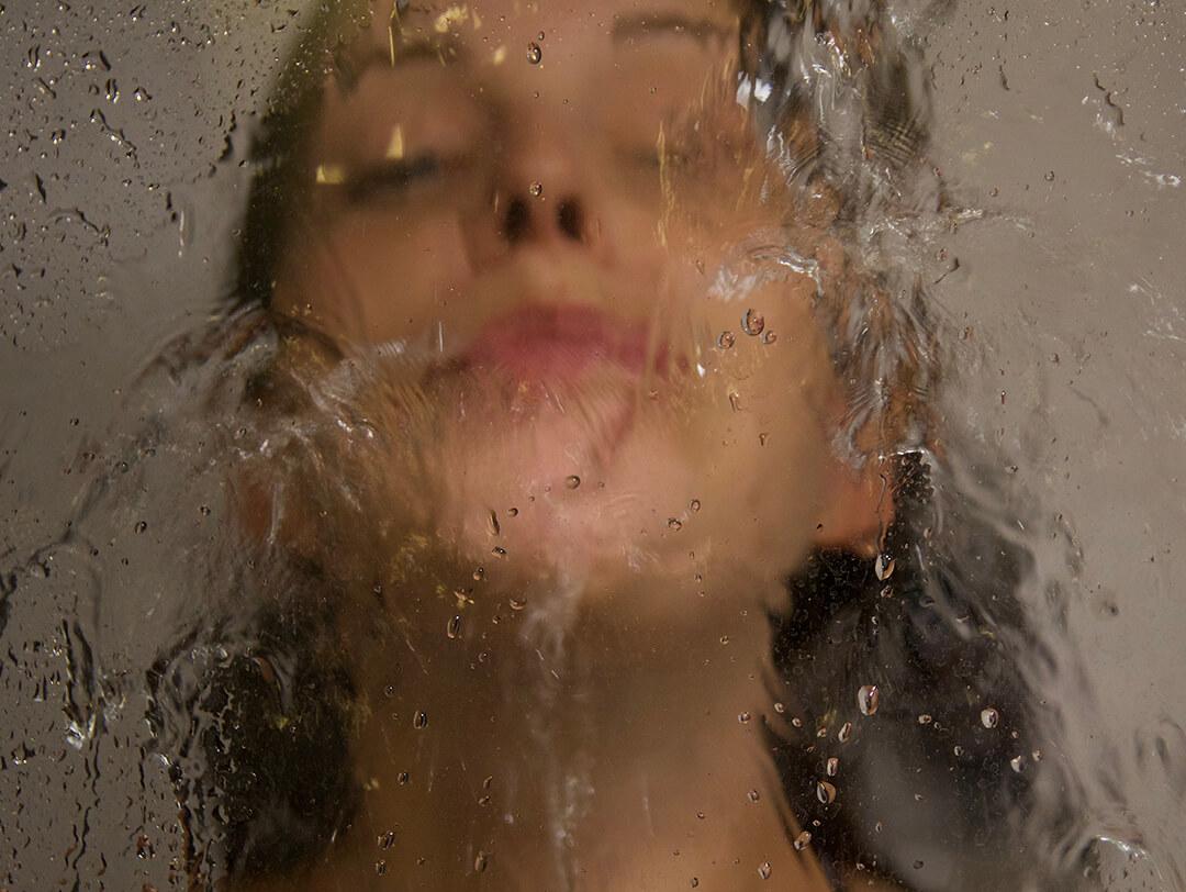 Close-Up Of Woman Bathing In Bathroom Seen Through Window Desktop