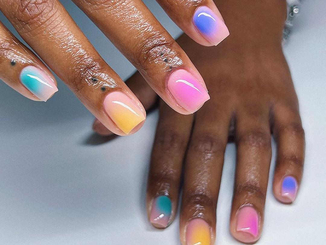 An image of a hands with colorful gel-nail against a white background Desktop
