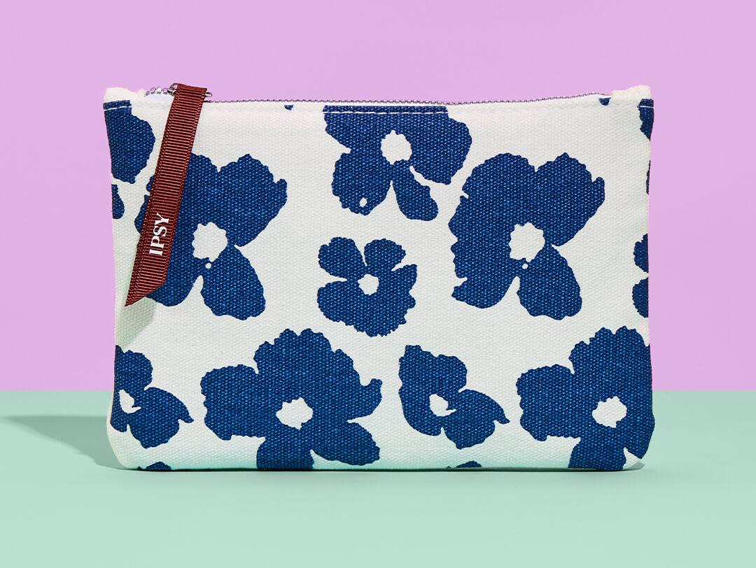 April 2023 IPSY Glam Bag on mint green surface and yellow background Desktop