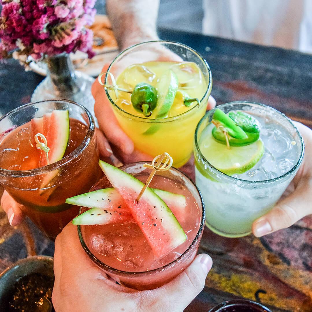 A closeup photo of different kinds of tropical blended fruit margaritas Mobile