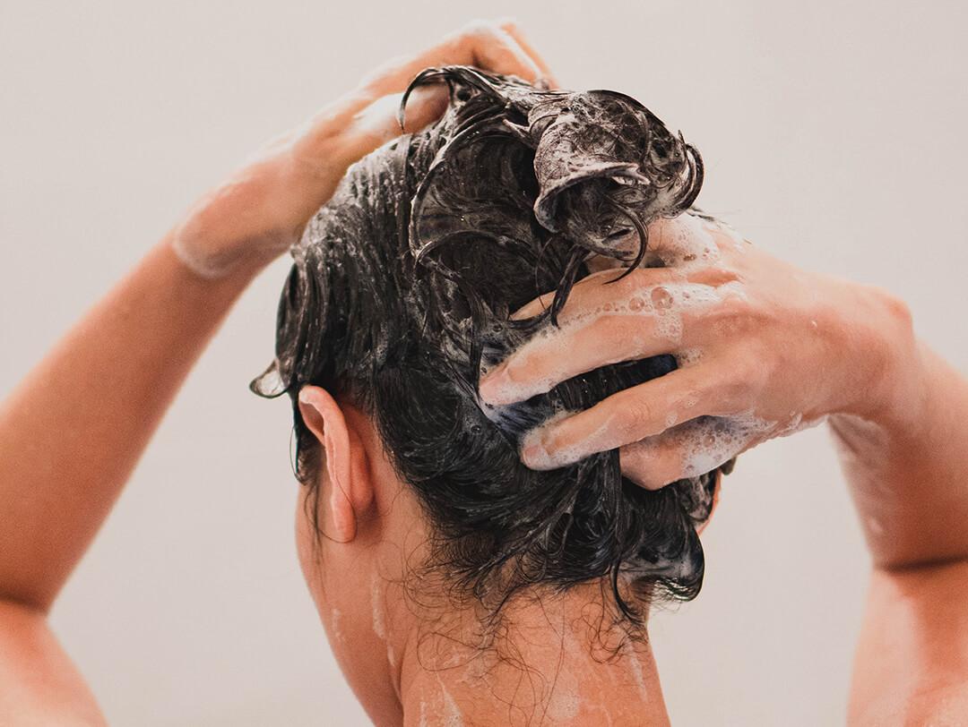 Woman washing her hair in the bathroom Desktop