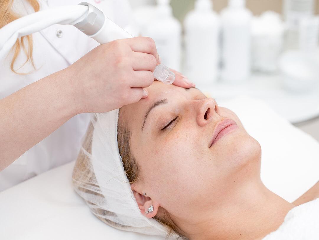An image of a woman getting microdermabrasion. Desktop