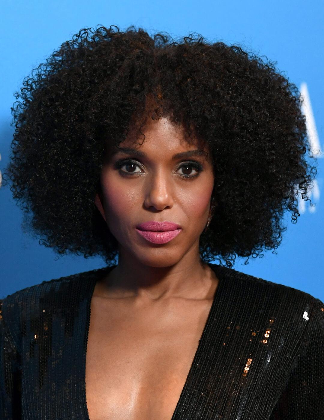 Close-up of Kerry Washington in a black sequined dress rocking an afro against blue background Mobile