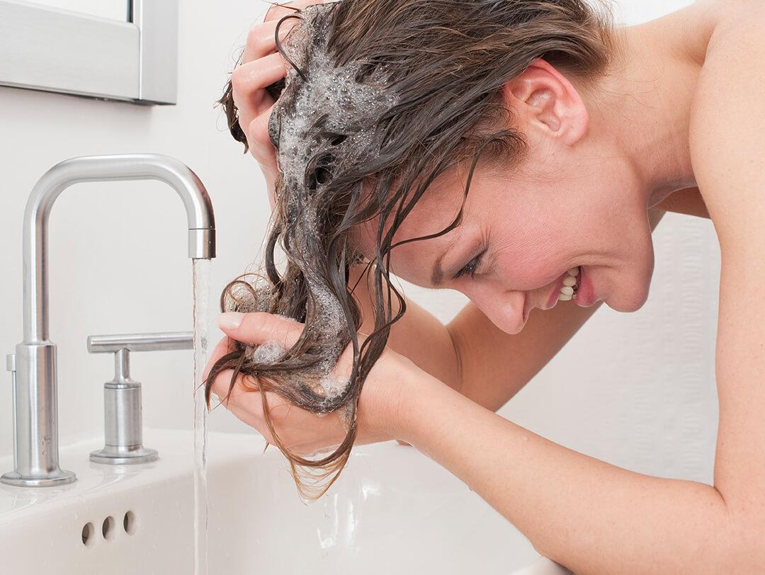 Woman washing her hair in the sink Desktop