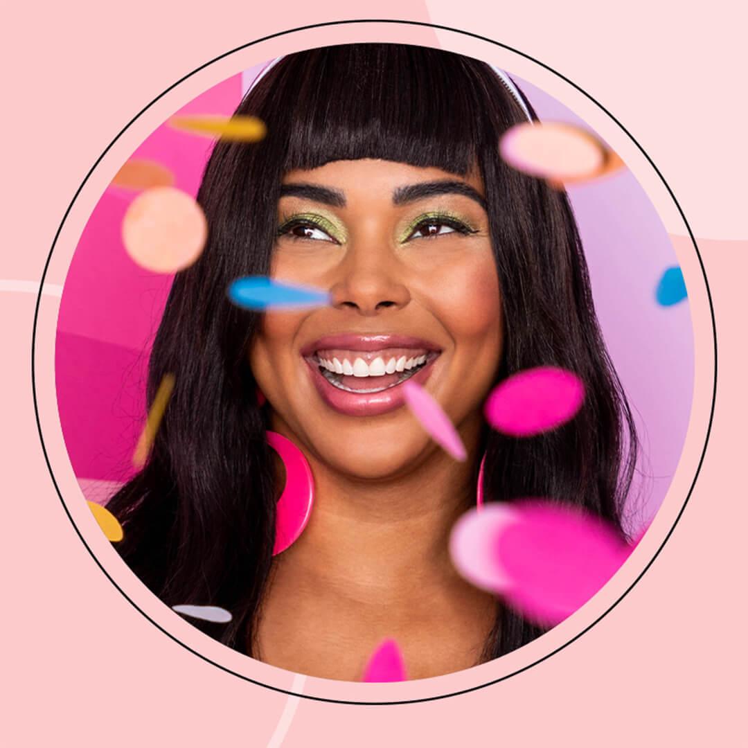 Profile image of a smiling Tabria Majors with confetti inside pink frame Mobile