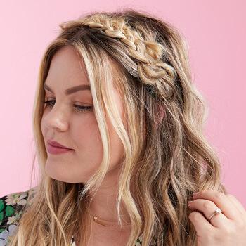A close-up image of a model with a crown braid hairstyle Mobile