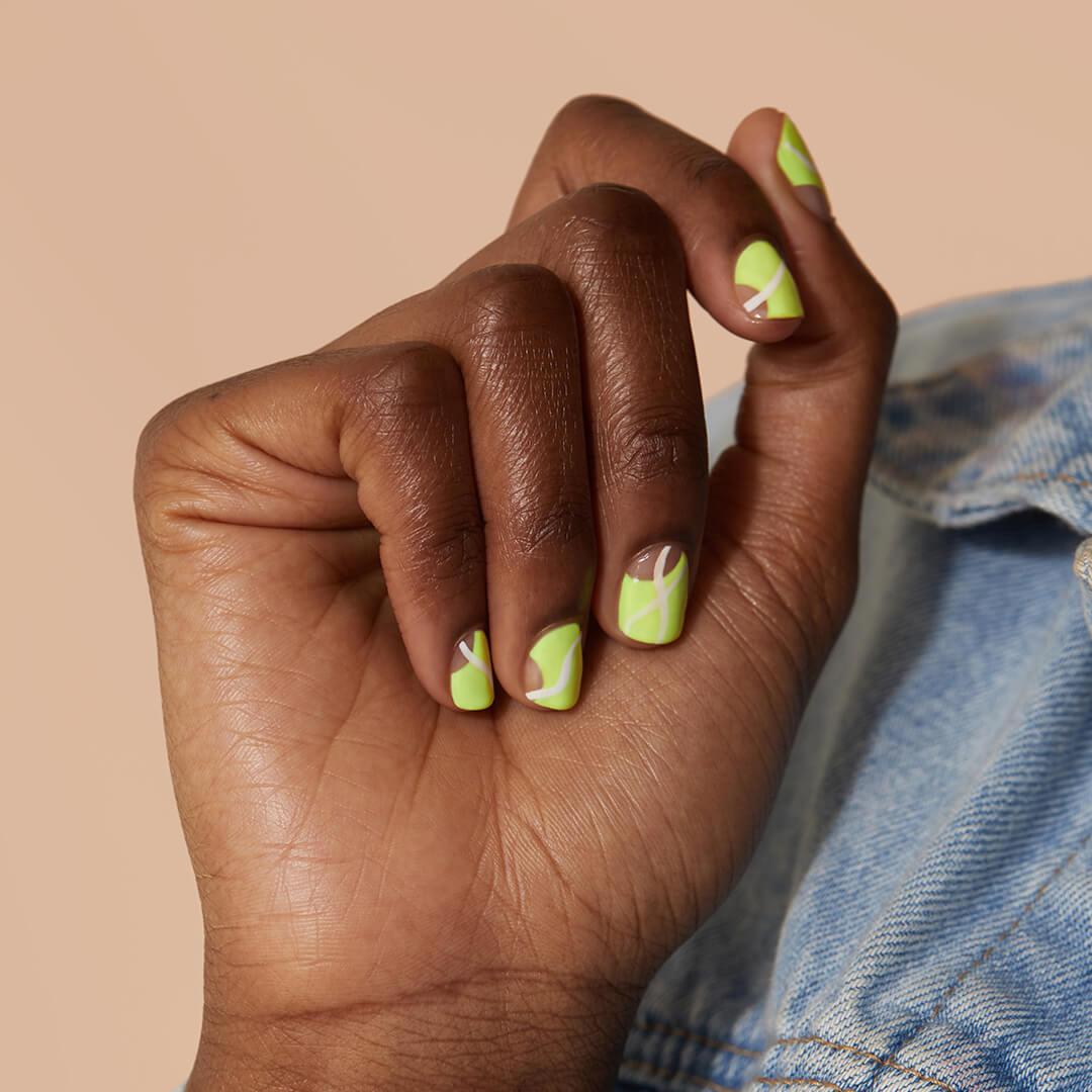 Close-up of a Black model's hand with slime green abstract nail art Mobile
