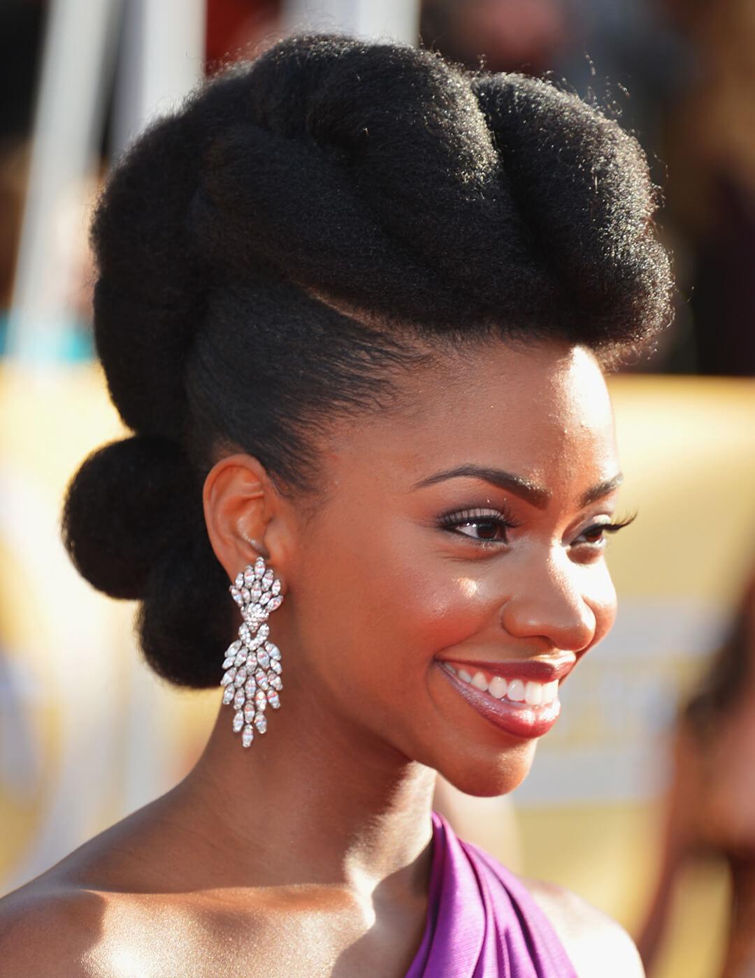 Close-up of Teyonah Parris looking glamorous with a classic up-do hairstyle and dangling diamond earrings Desktop