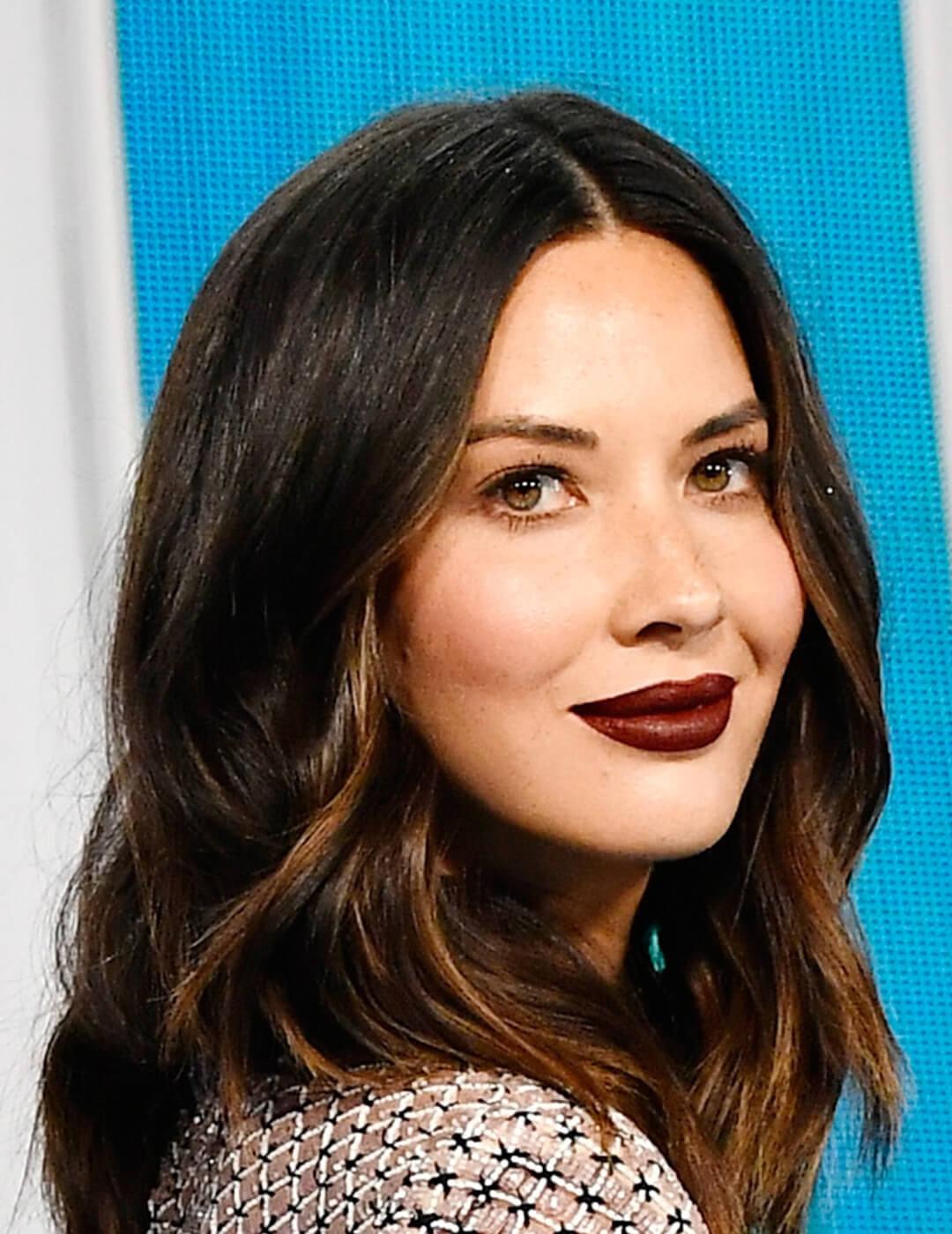 Close-up of Olivia Munn looking chic in minimal face makeup paired with dark burgundy lips Mobile