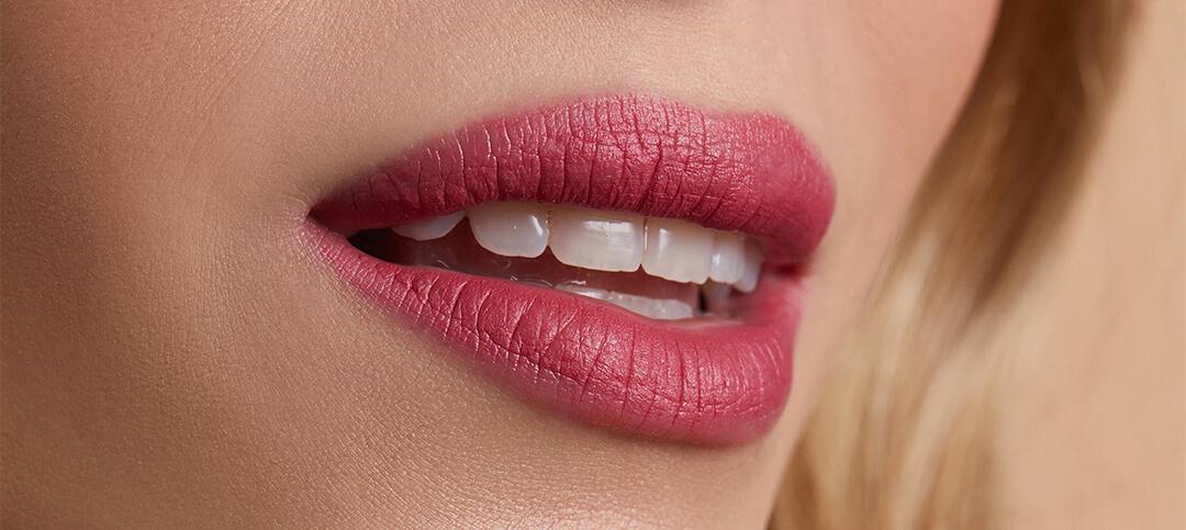 Close-up image of a model's lips with pink lipstick Desktop
