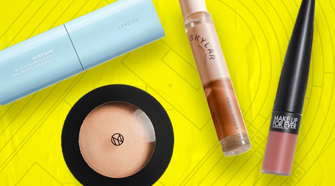 Skincare, makeup, and hair care products and tools from various brands scattered on yellow background Desktop