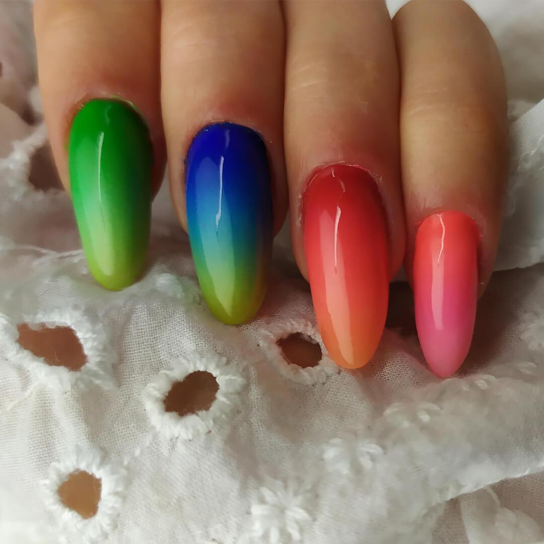 Close-up of a woman's rainbow ombré nail art Desktop