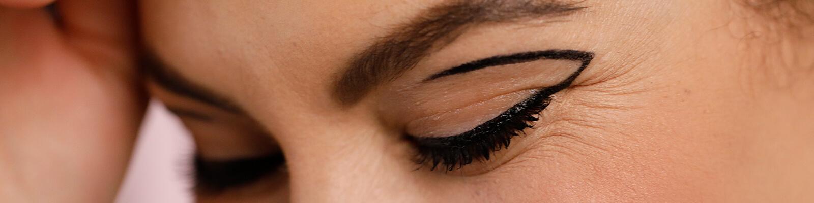 A closeup image of a model rocking a negative space eyeliner look Desktop