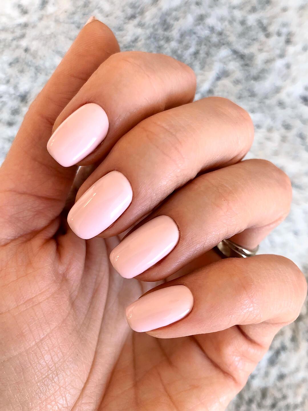 Close-up image of a woman's light pink mani Desktop
