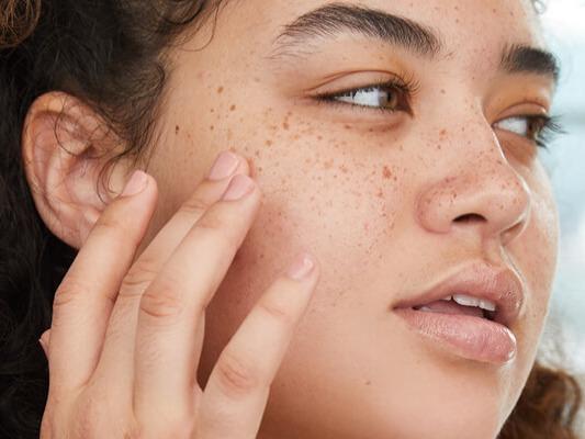 Grace & Stella Co. Acne Treatment Facial Sheet Masks and Cierra Creer touching her cheek Desktop