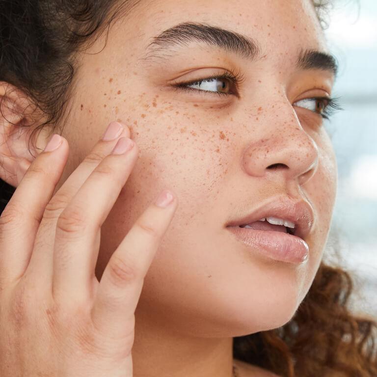 Grace & Stella Co. Acne Treatment Facial Sheet Masks and Cierra Creer touching her cheek Mobile