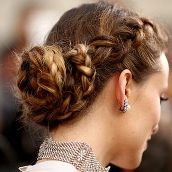 A close-up image of Olivia Wilde's Boho braided bun hairstyle Mobile