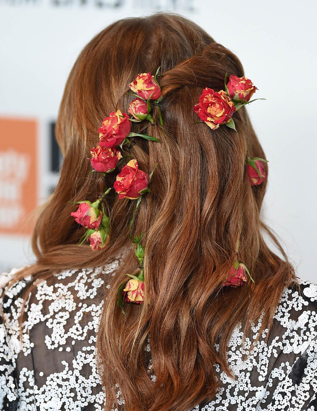Back view of Emma Stone's hair embellished with flowers Mobile