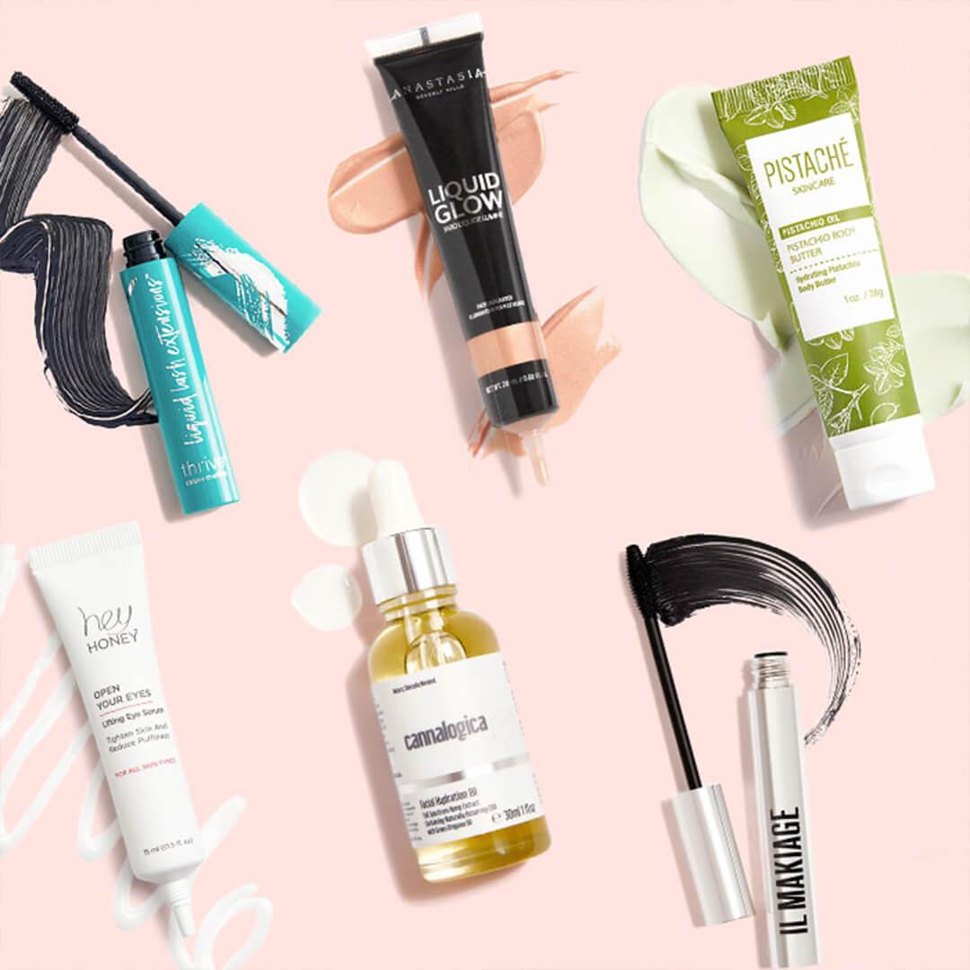 Makeup and skincare products swatched on light pink background Desktop