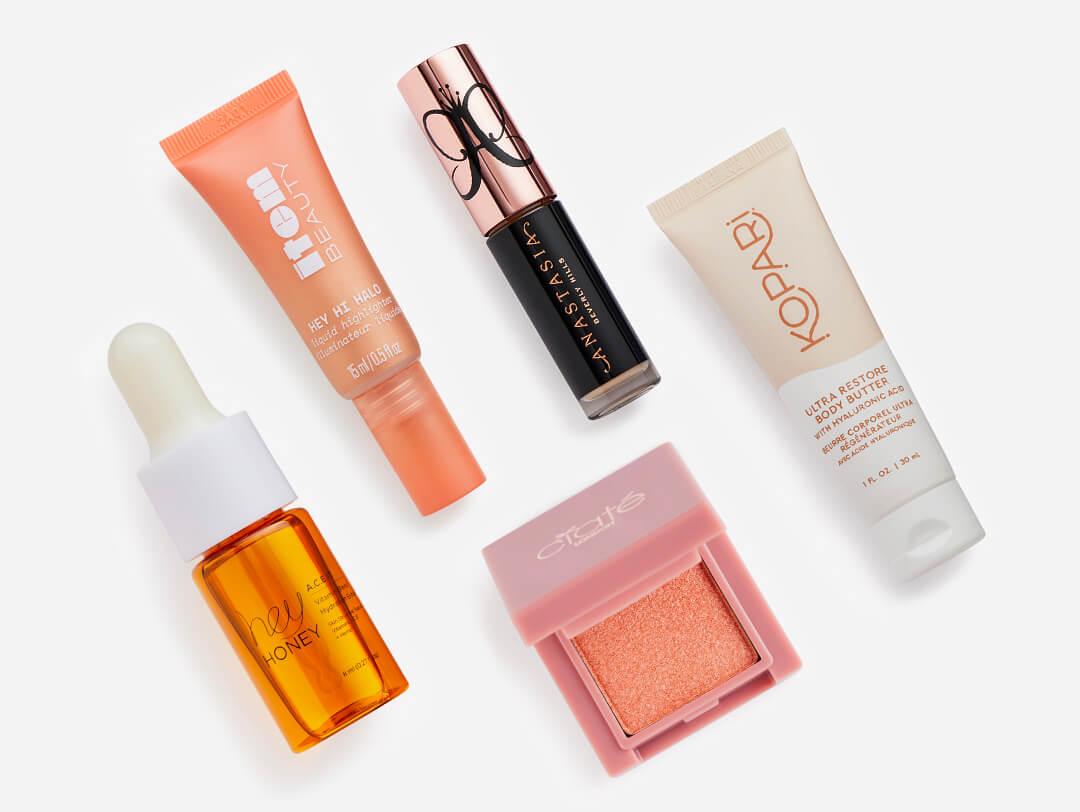 Makeup and skincare products from the October 2022 IPSY Glam Bag on white background Desktop
