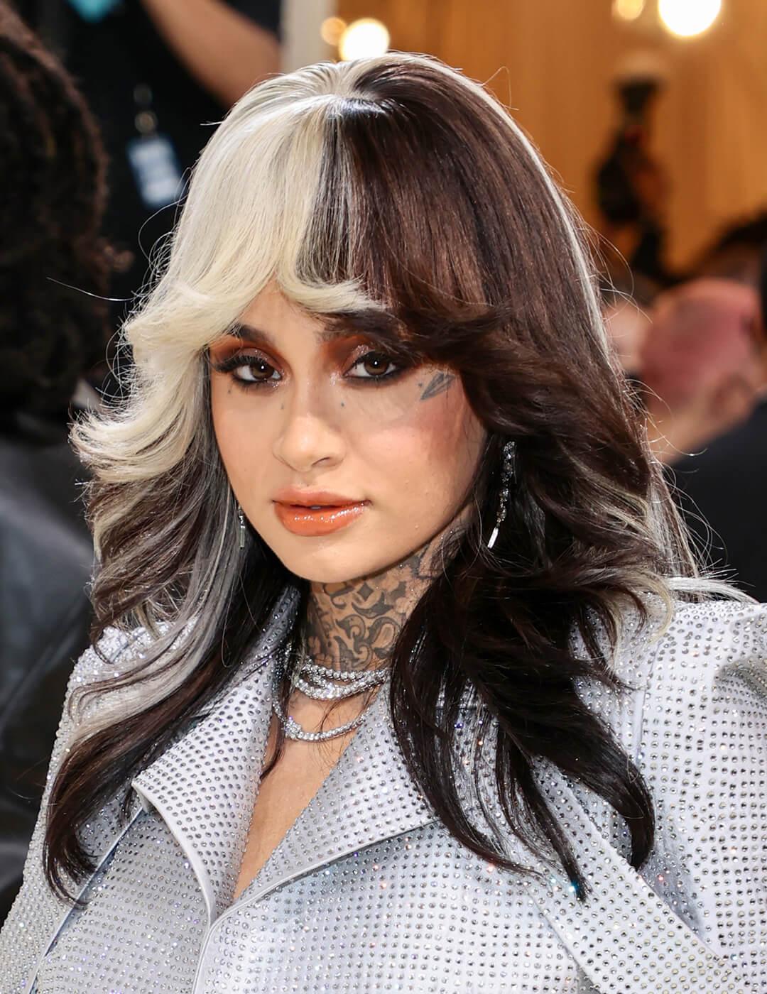 Kehlani rocking the red carpet in a black and white colored hairstyle and futuristic silver outfit Mobile