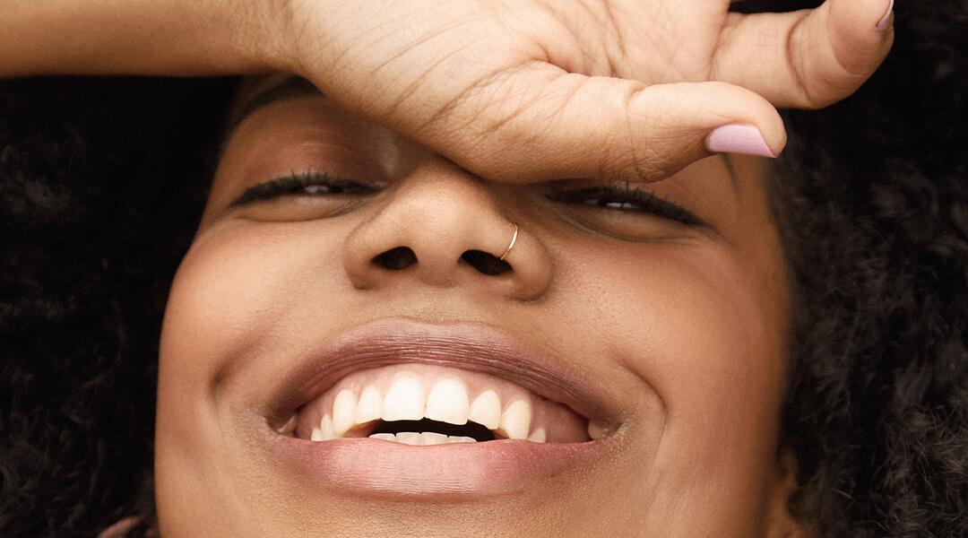 An image of a smiling model. Desktop