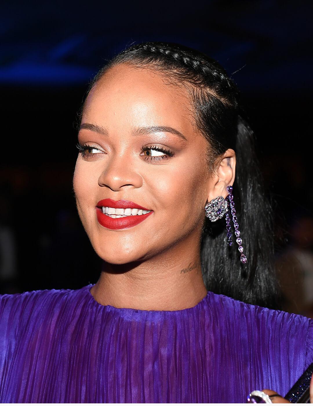 Rihanna looking glamorous in a purple dress and side braided ponytail hairstyle Desktop
