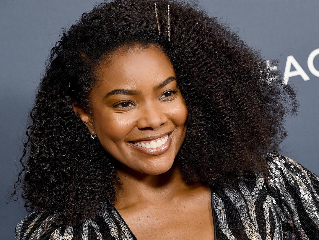 Gabrielle Union in a black and silver sequined dress smiling Desktop