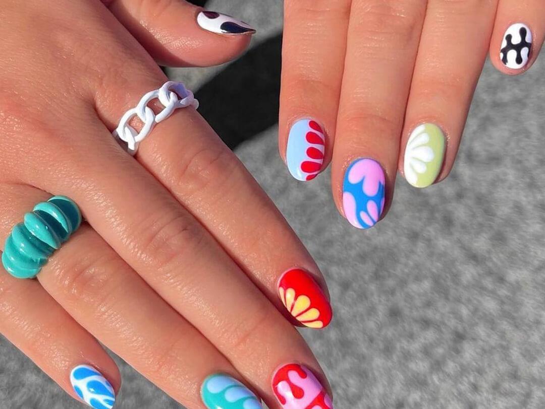 Close-up of woman's hands with cute and colorful nail art Desktop