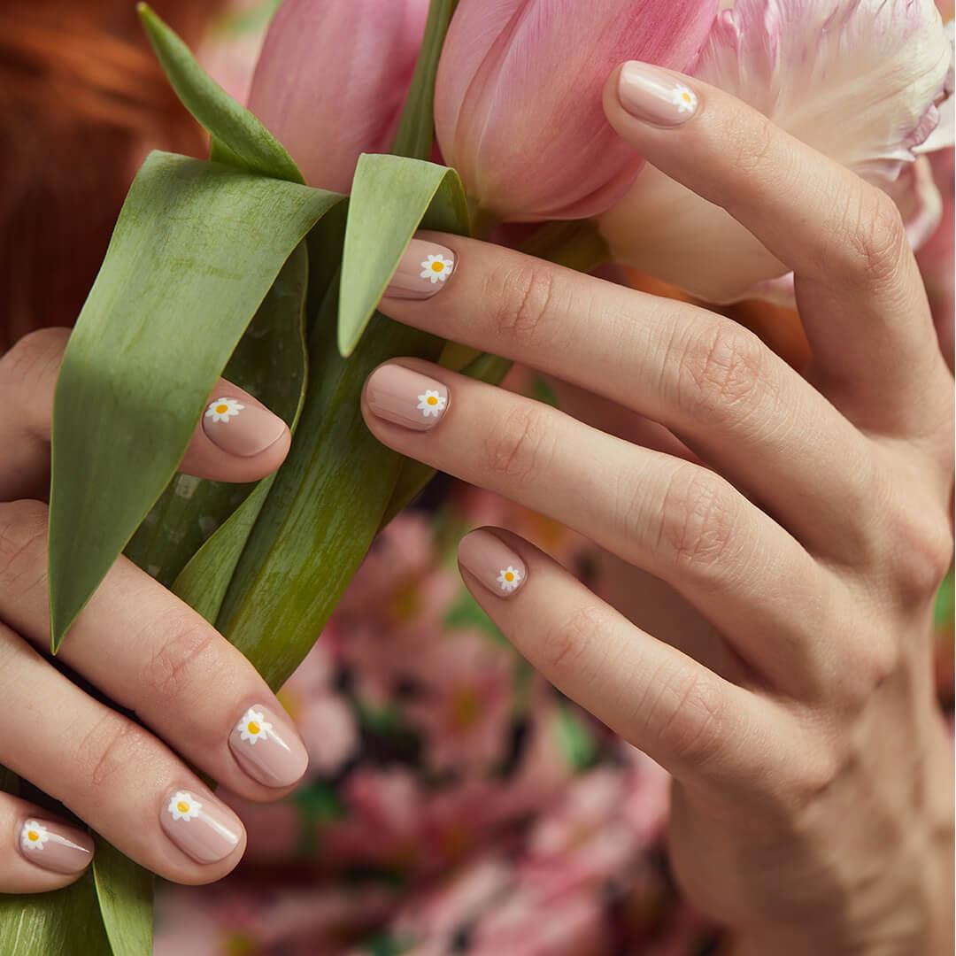 Close-up of model's hands with daisies nail art holding flowers Mobile
