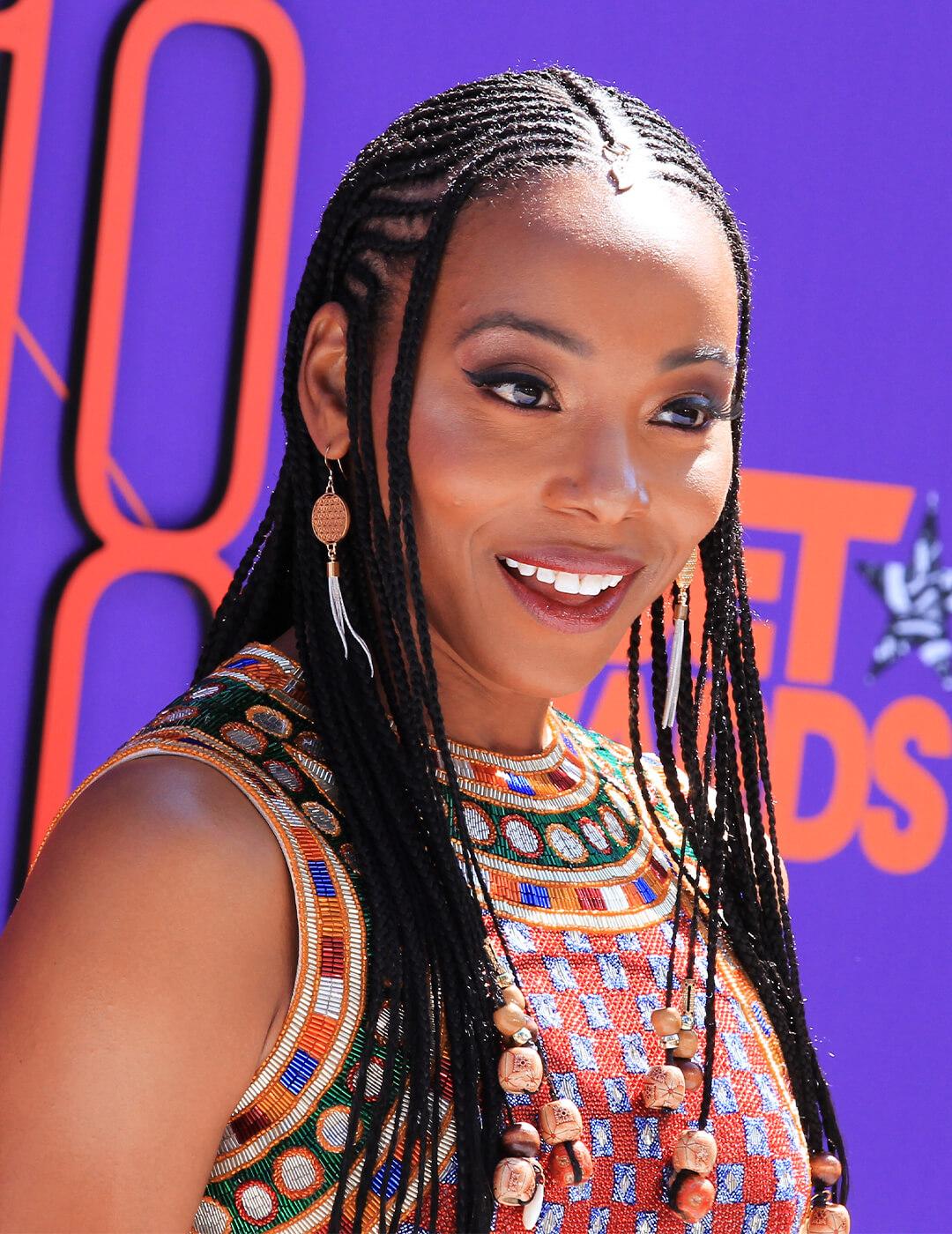 Erica Ash in a tribal-patterned dress rocking Fulani Braids hairstyle Desktop