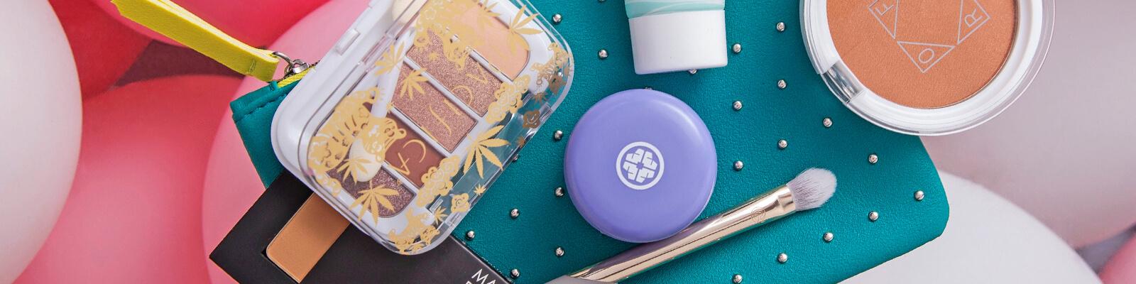 An image of the March Glam Bag, balloons, and some March products. Desktop