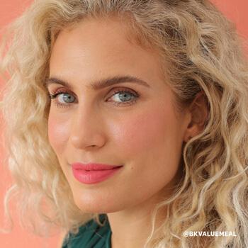 An image of a blonde model with a no-makeup makeup look and feather brows paired with a nude pink lipstick Mobile