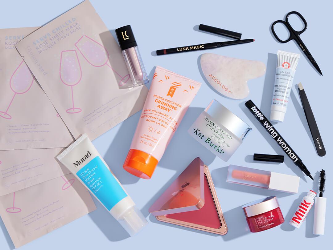 Beauty and makeup products and tools scattered on light blue background Desktop