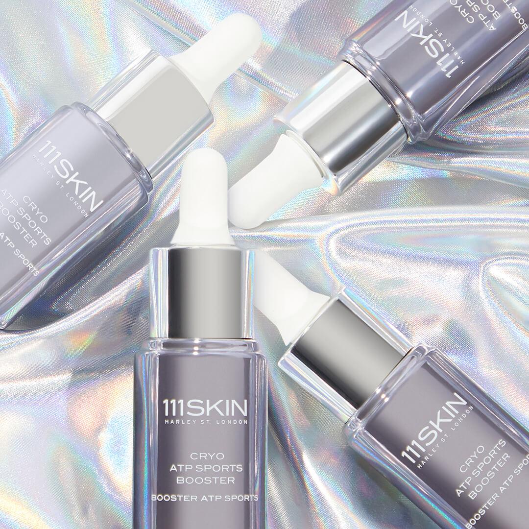 Close-up image of four bottles of 111SKIN Cryo ATP Sports Booster on chrome background Desktop