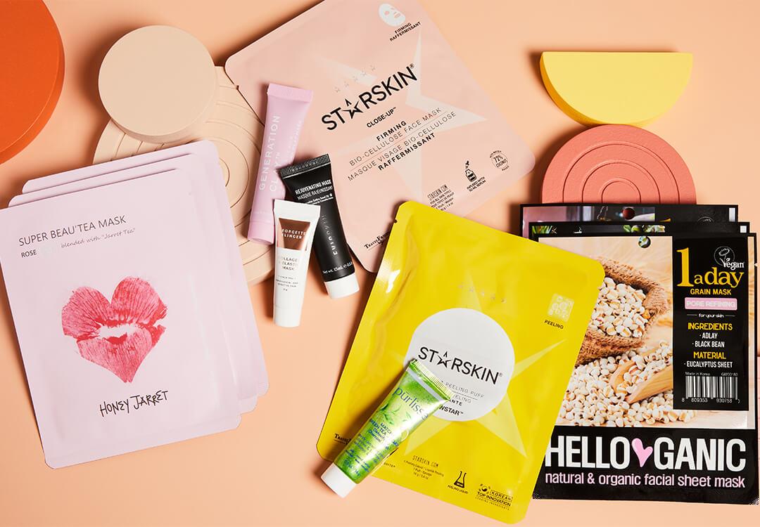 Different types of face masks on peach background Desktop