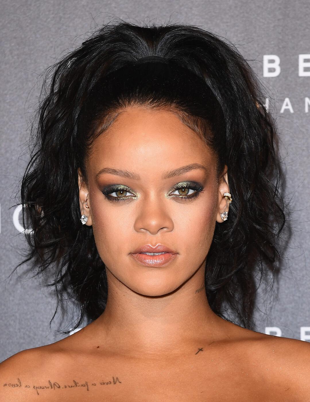 Rihanna looking glam in a smokey eyeshadow look and high ponytail hairstyle Desktop
