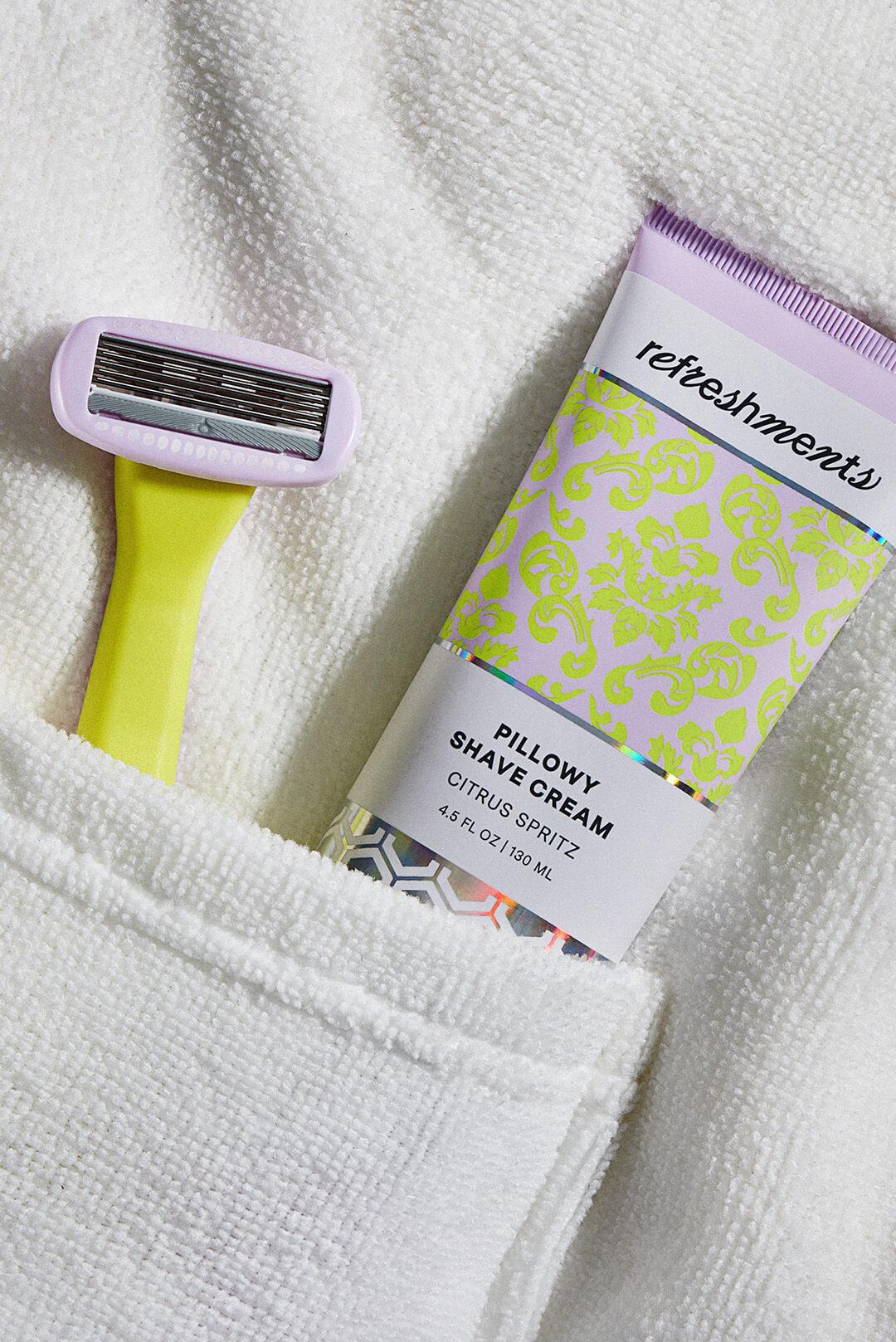 A photo of a razor and a tube of shaving cream tucked into a white bathrobe pocket Desktop