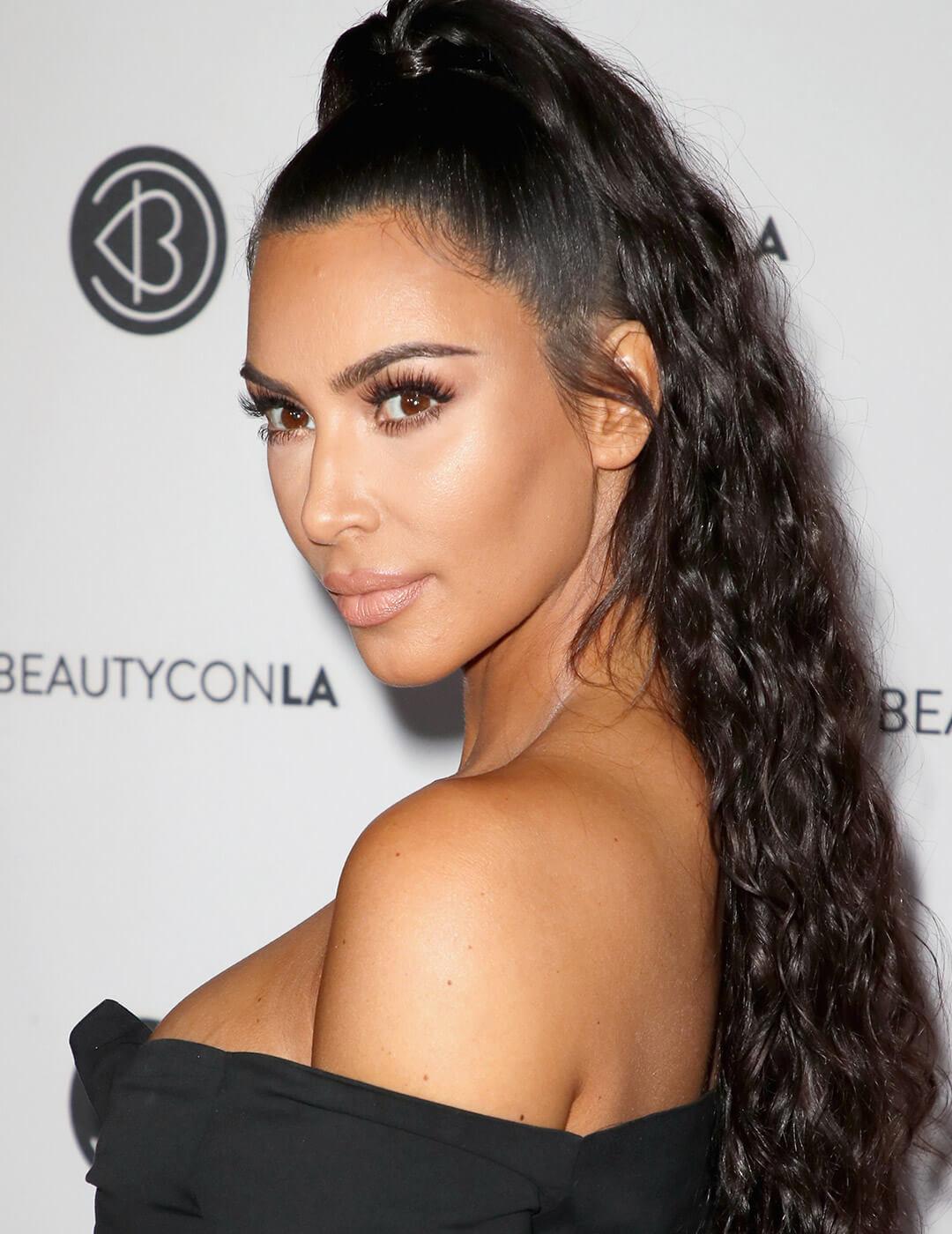 A photo of Kim Kardashian with a fountain hairstyle Desktop