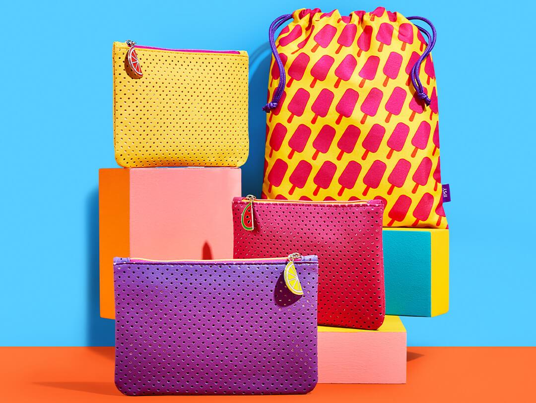 June 2022 IPSY Glam Bags and Glam Bag Plus bags on blue and orange background Desktop