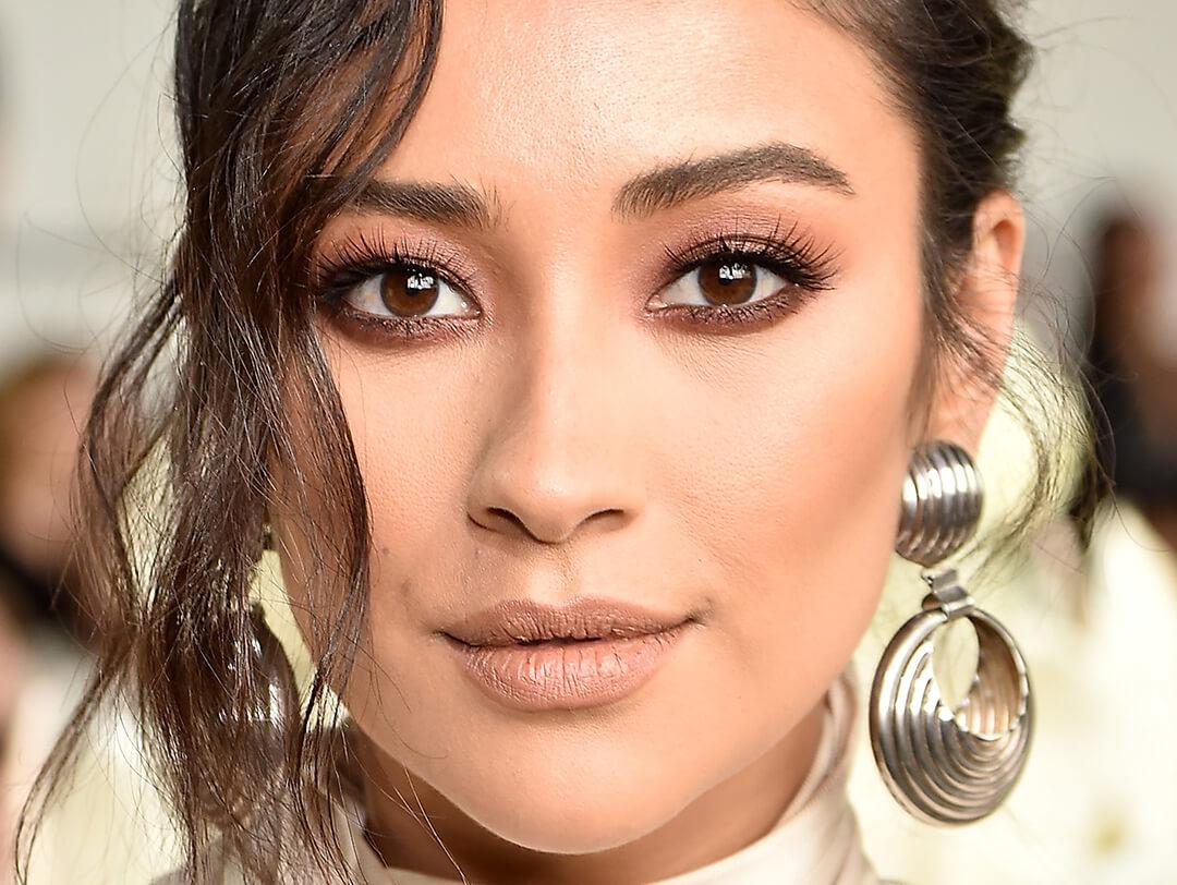 Close-up of Shay Mitchell rocking a neutral makeup look and bold earrings Desktop