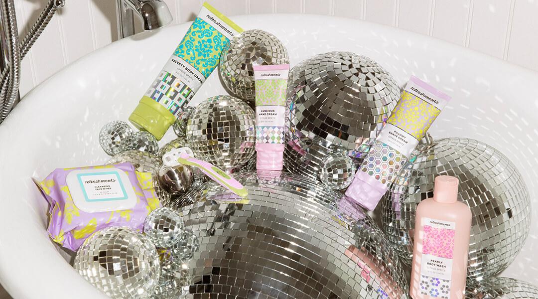 Image of skincare products and disco balls in a bathtub Desktop