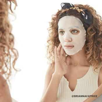 A model applies a sheet mask. Mobile