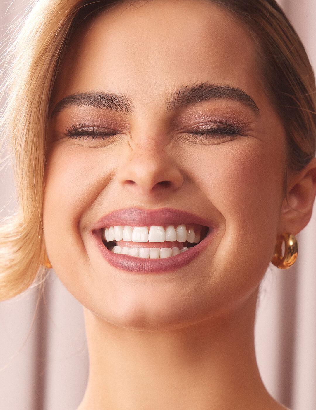 Close-up of a smiling Addison Rae rocking a neutral makeup look Desktop