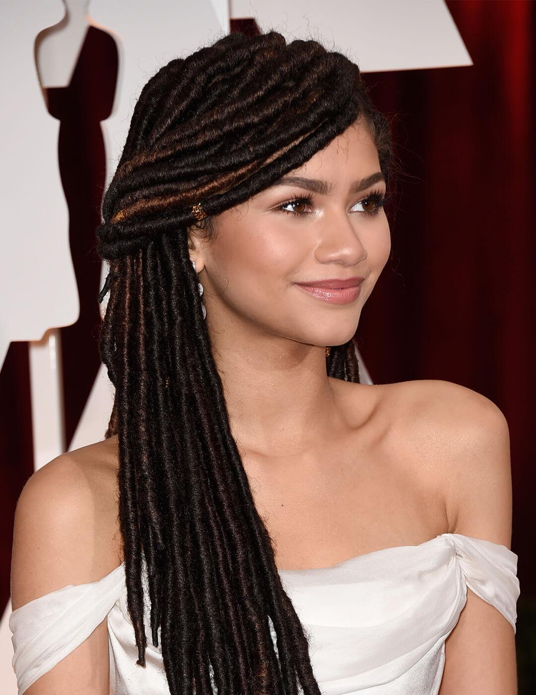 Zendaya rocking a white dress and box braids half up hairstyle Desktop