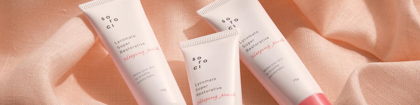 An image of 3 SOROCI Lycomato Super Restorative Sleeping Masks on top of peach colored cloth Desktop